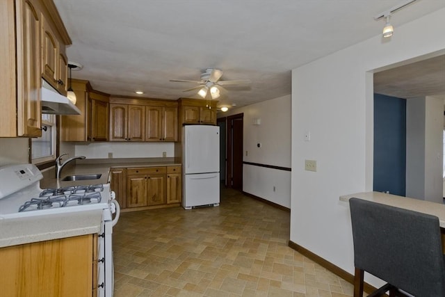 kitchen featuring ceiling fan, white appliances, and sink