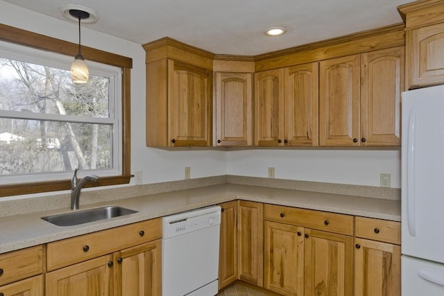 kitchen featuring sink, white appliances, and hanging light fixtures