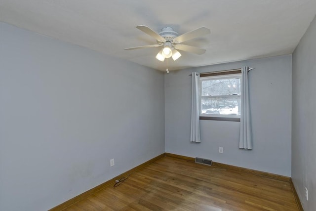 unfurnished room with hardwood / wood-style flooring and ceiling fan