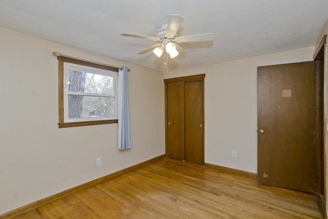 unfurnished bedroom with ceiling fan, light hardwood / wood-style floors, and a closet