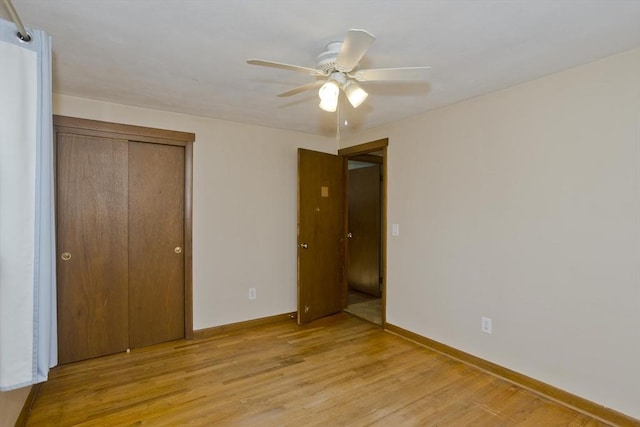 unfurnished bedroom with a closet, ceiling fan, and light wood-type flooring