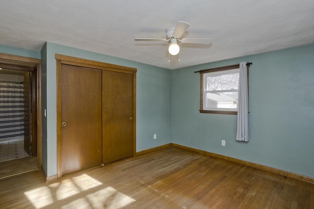 unfurnished bedroom featuring ceiling fan, a closet, and light hardwood / wood-style flooring