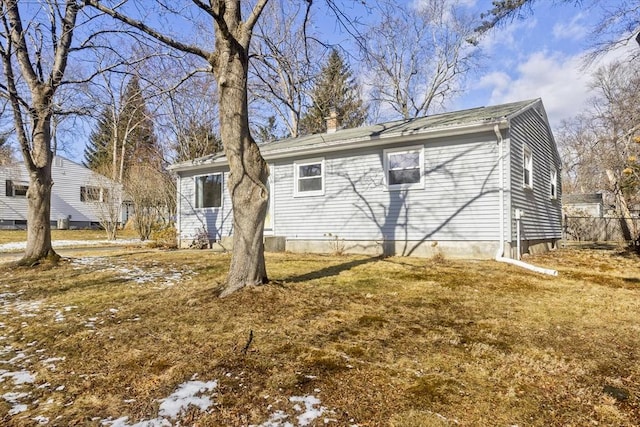 rear view of property featuring a yard