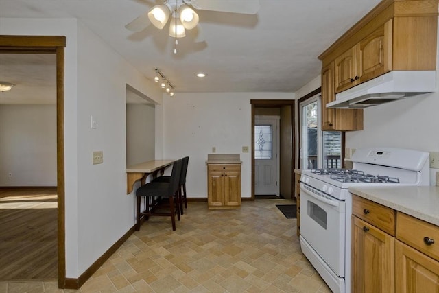 kitchen with ceiling fan and gas range gas stove