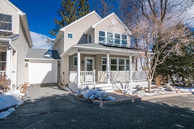 view of front of home with a garage, aphalt driveway, a porch, and a shingled roof