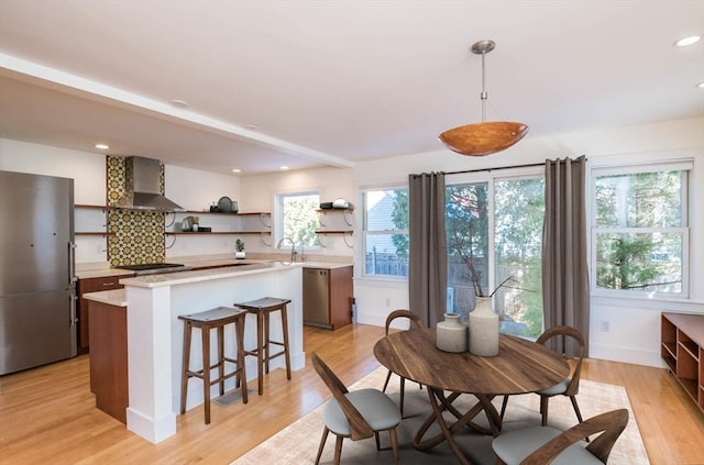 dining space featuring baseboards, recessed lighting, and light wood-style floors