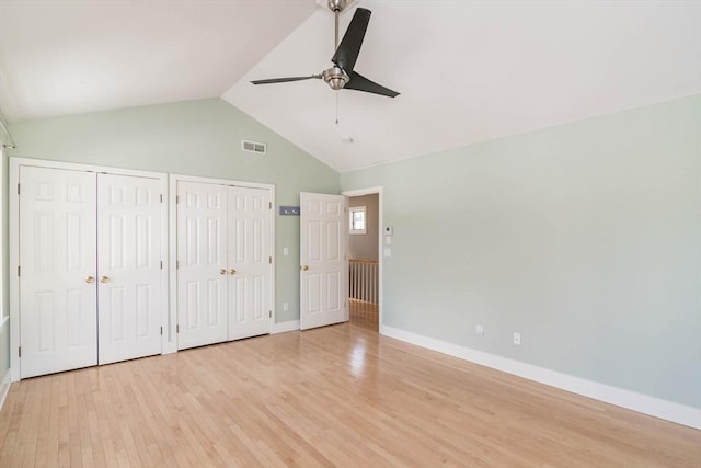 unfurnished bedroom with baseboards, visible vents, ceiling fan, light wood-type flooring, and two closets