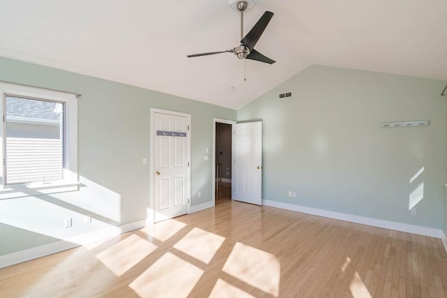 unfurnished bedroom with lofted ceiling, baseboards, visible vents, and light wood-style floors