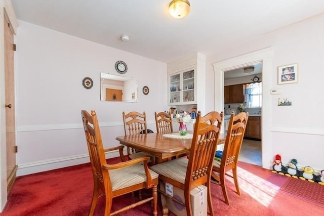 dining area featuring light carpet