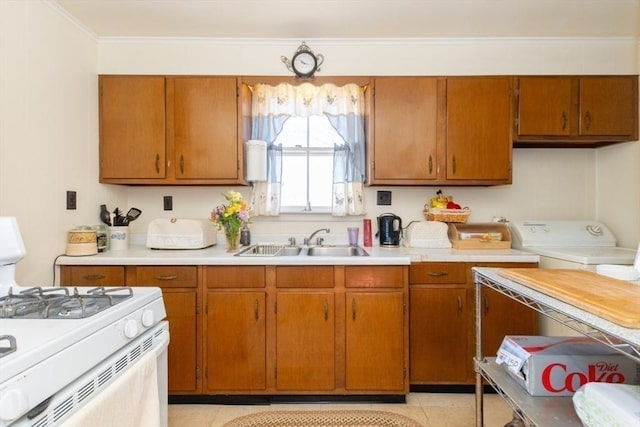 kitchen with a sink, brown cabinets, and white gas range oven