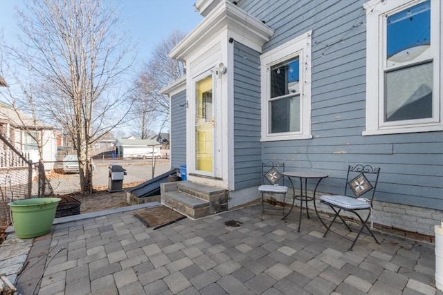 view of patio with entry steps and fence