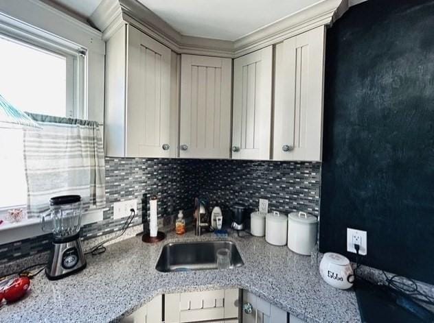 kitchen with decorative backsplash and a sink