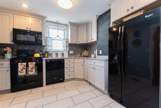 kitchen featuring decorative light fixtures, tasteful backsplash, black appliances, and light countertops