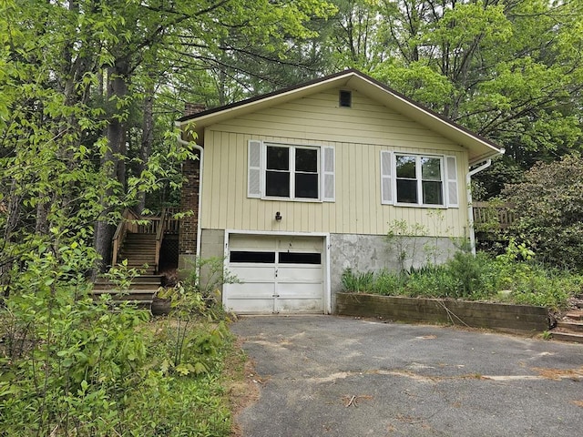 288 Leverett Rd, Shutesbury, MA 01072 - view of front facade featuring driveway, a garage, and stairs