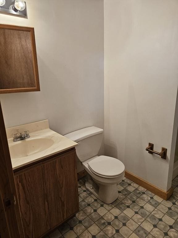 288 Leverett Rd, Shutesbury, MA 01072 - half bathroom featuring toilet, vanity, and baseboards