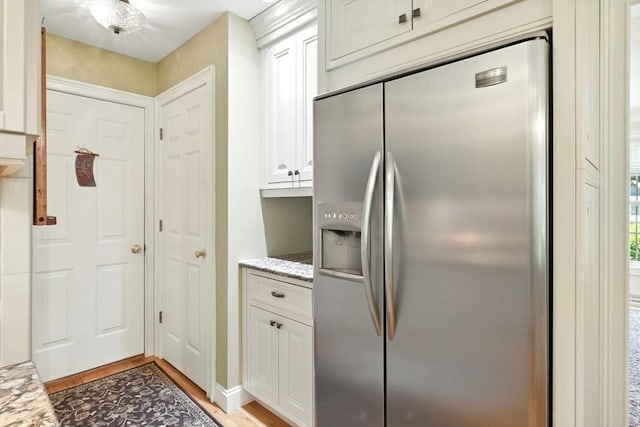 34 Hawks Cir, Westfield, MA 01085 - kitchen featuring stainless steel fridge, light wood-type flooring, light stone countertops, and white cabinets