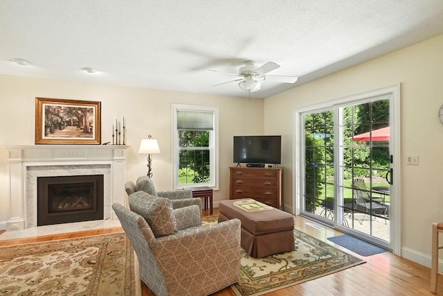 34 Hawks Cir, Westfield, MA 01085 - living area featuring wood finished floors, ceiling fan, plenty of natural light, and a fireplace