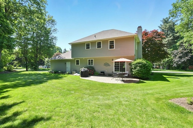 34 Hawks Cir, Westfield, MA 01085 - back of house with a patio area, a chimney, and a lawn