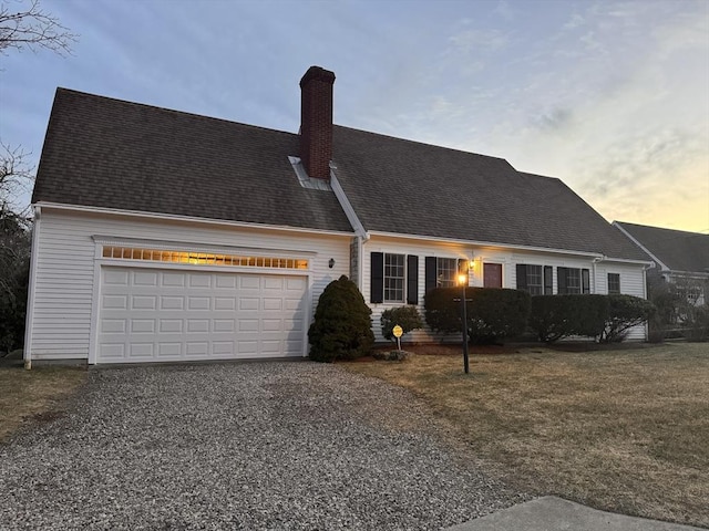 view of front of house with gravel driveway, roof with shingles, a chimney, and an attached garage