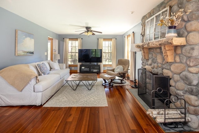 living room with wood-type flooring and a ceiling fan
