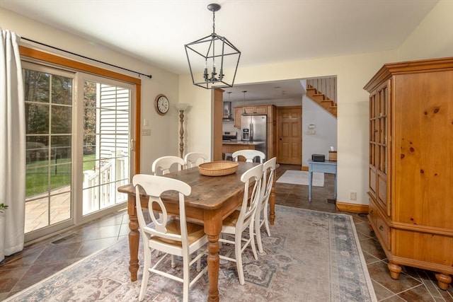 tiled dining area with visible vents and a notable chandelier