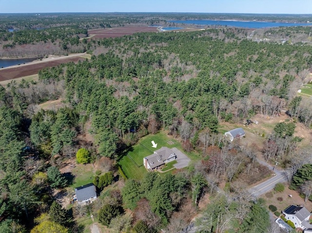 birds eye view of property featuring a water view and a forest view