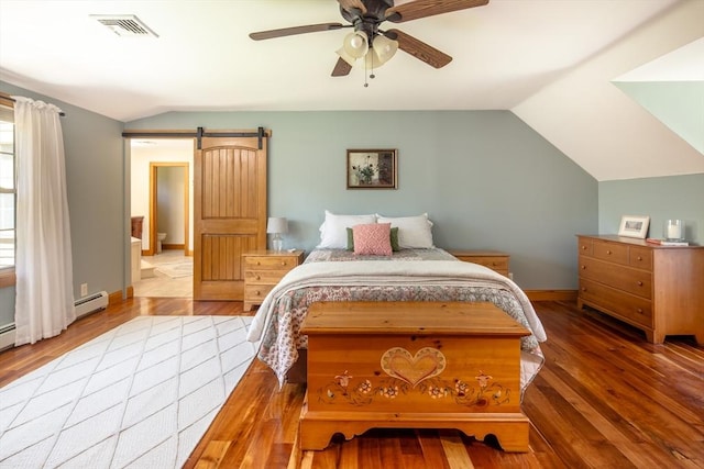 bedroom featuring visible vents, ceiling fan, wood finished floors, and vaulted ceiling