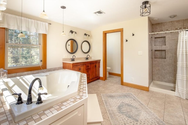bathroom featuring a tile shower, vanity, toilet, tile patterned floors, and a bath