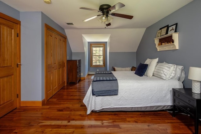 bedroom with visible vents, baseboards, wood finished floors, and a closet