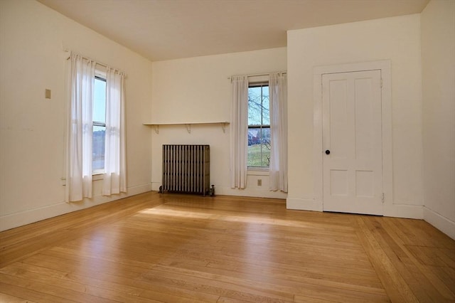 41 Coombs Hill Rd, Shelburne, MA 01340 - unfurnished living room with radiator heating unit, light wood-type flooring, and baseboards