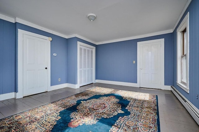 41 Coombs Hill Rd, Shelburne, MA 01340 - foyer entrance with a baseboard radiator, wood finished floors, baseboards, and ornamental molding
