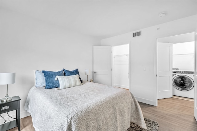 bedroom featuring washer / clothes dryer and hardwood / wood-style floors