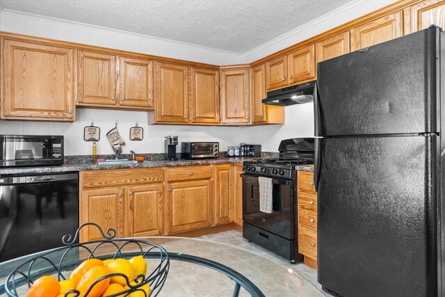29 Sampson St Unit 29, Grafton, MA 01560 - kitchen with black appliances, under cabinet range hood, a textured ceiling, brown cabinets, and light tile patterned flooring