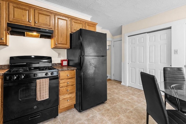 29 Sampson St Unit 29, Grafton, MA 01560 - kitchen with black appliances, under cabinet range hood, brown cabinets, a textured ceiling, and light tile patterned flooring