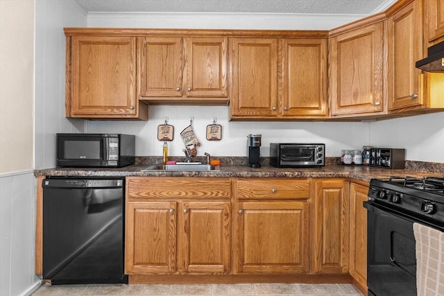 29 Sampson St Unit 29, Grafton, MA 01560 - kitchen with black appliances, a sink, brown cabinets, dark countertops, and a wainscoted wall