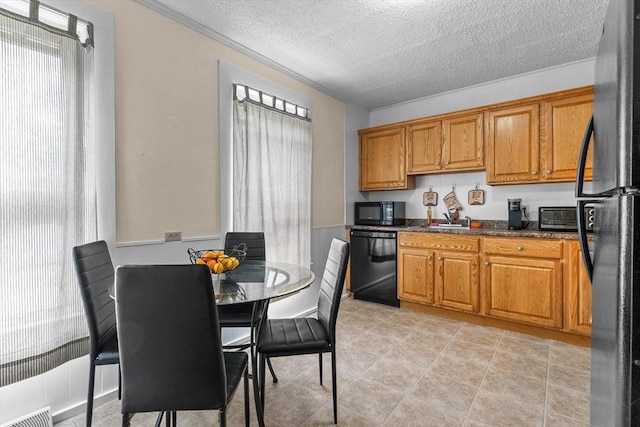 29 Sampson St Unit 29, Grafton, MA 01560 - kitchen with black appliances, plenty of natural light, a textured ceiling, and brown cabinets