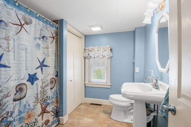 231 W Main St, Georgetown, MA 01833 - bathroom with baseboards, tile patterned flooring, toilet, and a shower with shower curtain