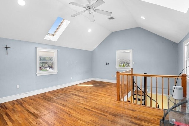 231 W Main St, Georgetown, MA 01833 - additional living space with a skylight, lofted ceiling, wood-type flooring, baseboards, and plenty of natural light