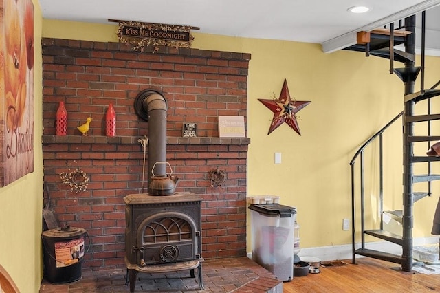 231 W Main St, Georgetown, MA 01833 - living room with a wood stove, wood finished floors, and baseboards