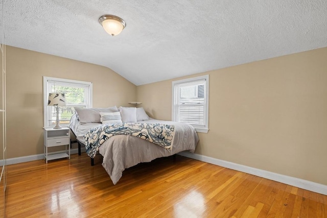 70 Williams St, Quincy, MA 02171 - bedroom with a textured ceiling, lofted ceiling, and light wood-type flooring