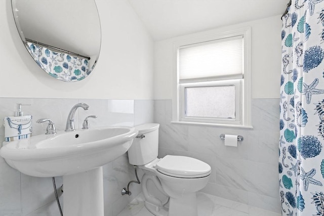 70 Williams St, Quincy, MA 02171 - full bath featuring tile walls, marble look tiles, a shower with shower curtain, and a wainscoted wall