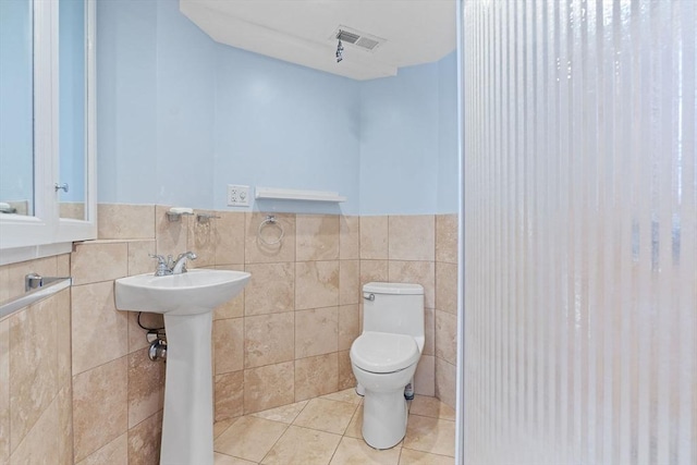 70 Williams St, Quincy, MA 02171 - bathroom featuring tile patterned flooring, tile walls, and a wainscoted wall