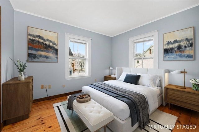 bedroom featuring light wood-style floors, baseboards, and ornamental molding