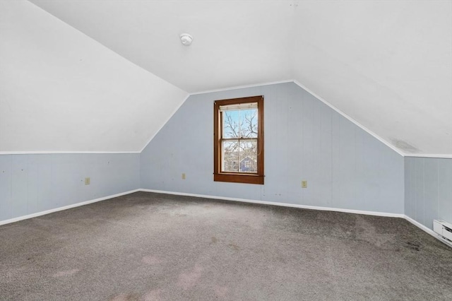 bonus room featuring vaulted ceiling and carpet