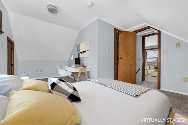 bedroom with lofted ceiling, carpet flooring, and baseboards