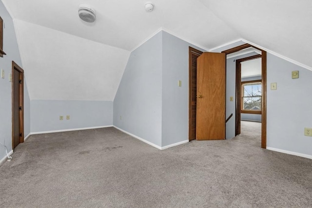 bonus room featuring carpet, baseboards, and vaulted ceiling