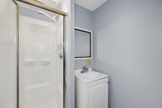 full bath featuring a stall shower and vanity