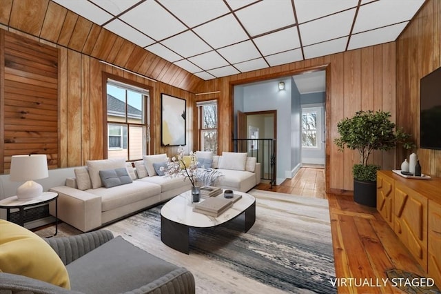 living room with wood walls and light wood finished floors