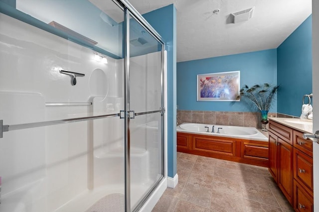 bathroom with vanity, a bath, visible vents, and a stall shower