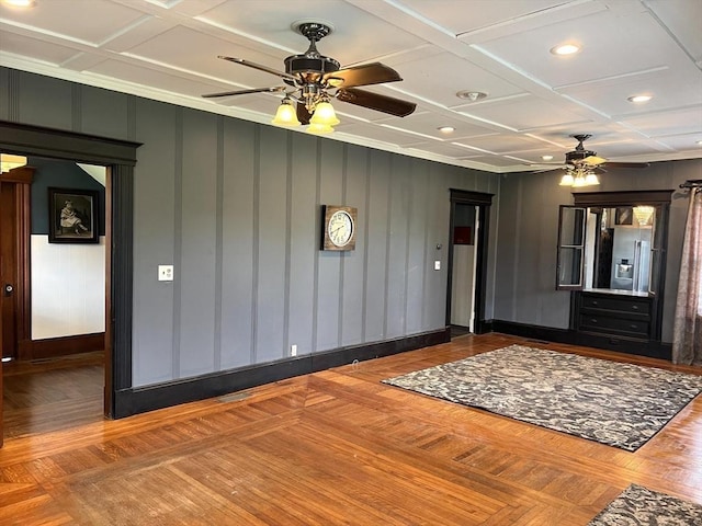 interior space featuring parquet floors, recessed lighting, coffered ceiling, and baseboards